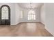 Spacious living room with hardwood floors, a chandelier, a decorative door, and plenty of natural light at 17025 E De Anza Dr, Fountain Hills, AZ 85268