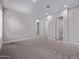Spacious bedroom with gray carpet, three white doors, recessed lighting and neutral walls at 17118 N 50Th Way, Scottsdale, AZ 85254