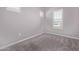 Empty bedroom with neutral walls, plush carpet, white trim and two shuttered windows at 17118 N 50Th Way, Scottsdale, AZ 85254