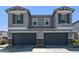 Beautiful gray home with gray garage doors and stone accents enhancing curb appeal at 17118 N 50Th Way, Scottsdale, AZ 85254