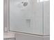 Glass shower with a shower head and a tiled shelf at 17118 N 50Th Way, Scottsdale, AZ 85254