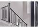 Modern staircase with a gray carpet and a striking black geometric railing at 17118 N 50Th Way, Scottsdale, AZ 85254