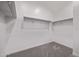 Walk-in closet with carpeted floor and white walls with multiple shelves and rods for storage at 17118 N 50Th Way, Scottsdale, AZ 85254