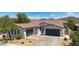 Attractive single-Gathering home boasts a three-car garage, desert landscaping, and a terracotta roof at 1720 W Aloe Vera Dr, Phoenix, AZ 85085