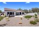 An expansive backyard is enhanced by a travertine patio, synthetic lawn and a built-in spa at 1720 W Aloe Vera Dr, Phoenix, AZ 85085