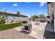 A backyard with a built-in grill, outdoor fire pit, spa, and comfortable seating offers space to relax at 1720 W Aloe Vera Dr, Phoenix, AZ 85085