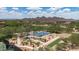 Aerial view of community basketball and sand volleyball court, surrounded by lush landscaping and mountain views at 1720 W Aloe Vera Dr, Phoenix, AZ 85085