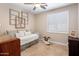 Bright bedroom featuring a daybed, window with shutters, neutral walls, and ceiling fan at 1720 W Aloe Vera Dr, Phoenix, AZ 85085