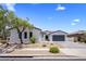 Inviting single-story home featuring a well-manicured front yard and a spacious driveway leading to a two-car garage at 1720 W Aloe Vera Dr, Phoenix, AZ 85085