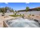 Close up of a backyard hot tub, overlooking desert landscaping, outdoor seating, and a built in barbeque at 1720 W Aloe Vera Dr, Phoenix, AZ 85085