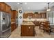 Gourmet kitchen featuring custom cabinets, granite countertops, stainless steel appliances, and a breakfast bar at 1720 W Aloe Vera Dr, Phoenix, AZ 85085