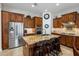 Well-appointed kitchen featuring a large center island with seating, granite countertops, and stainless steel appliances at 1720 W Aloe Vera Dr, Phoenix, AZ 85085