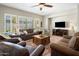 Comfortable living room featuring plantation shutters, a ceiling fan, and a neutral color palette, creating a welcoming atmosphere at 1720 W Aloe Vera Dr, Phoenix, AZ 85085