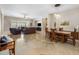 Open-concept living and dining area with tile flooring, recessed lighting, and large windows for natural light at 1720 W Aloe Vera Dr, Phoenix, AZ 85085