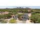 Gated neighborhood entrance featuring lush desert landscaping and picturesque mountain views at 1720 W Aloe Vera Dr, Phoenix, AZ 85085
