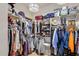 Large walk-in closet offering shelving units, multiple racks for hanging clothes, and overhead lighting at 1720 W Aloe Vera Dr, Phoenix, AZ 85085