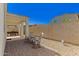Enjoy outdoor living with a covered patio, gravel landscaping, a stone fence, and tranquil seating at 17444 W Via De Luna Dr, Surprise, AZ 85387