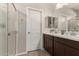 Bathroom featuring a double sink vanity, modern finishes, and a glass-enclosed shower at 17444 W Via De Luna Dr, Surprise, AZ 85387