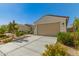 Charming single-story home featuring low maintenance landscaping and a two-car garage at 17444 W Via De Luna Dr, Surprise, AZ 85387