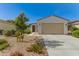 Charming single-story home featuring low maintenance landscaping and a two-car garage at 17444 W Via De Luna Dr, Surprise, AZ 85387