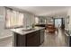 Open-concept kitchen boasts stainless steel appliances, granite countertops, and views of dining and living areas at 17444 W Via De Luna Dr, Surprise, AZ 85387