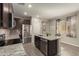 Well-equipped kitchen with stainless steel appliances, granite countertops, and an island at 17444 W Via De Luna Dr, Surprise, AZ 85387