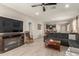 Spacious living room featuring a fireplace, modern furniture, and views of the kitchen at 17444 W Via De Luna Dr, Surprise, AZ 85387
