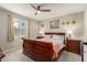 Well-lit main bedroom showcases a comfortable king bed, ceiling fan, and stylish decor at 17444 W Via De Luna Dr, Surprise, AZ 85387