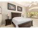Serene bedroom with a king-size bed, ceiling fan, and backyard views at 17796 W Andora St, Surprise, AZ 85388