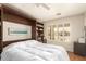 Bright bedroom featuring built-in shelves and a window view of the landscaped yard outside at 17796 W Andora St, Surprise, AZ 85388