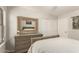 Bedroom features a large mirror, neutral color scheme, and a closet with sliding doors at 17796 W Andora St, Surprise, AZ 85388