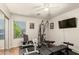 Home exercise room equipped with weight training equipment and an entertainment center at 17796 W Andora St, Surprise, AZ 85388