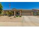 Charming single-story home featuring a neutral color scheme, well-maintained landscaping, and an American flag at 17796 W Andora St, Surprise, AZ 85388