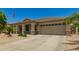 Charming single-story home featuring a neutral color scheme and a well-maintained xeriscaped front yard at 17796 W Andora St, Surprise, AZ 85388