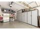 Spacious garage with epoxy floor, overhead racks, and cabinets for ample storage solutions at 17796 W Andora St, Surprise, AZ 85388