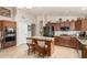 Spacious kitchen boasts a functional island, sleek appliances, and warm, inviting tones at 17796 W Andora St, Surprise, AZ 85388