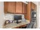 Convenient office nook includes granite countertops, custom cabinets, and built-in appliances at 17796 W Andora St, Surprise, AZ 85388