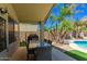 Outdoor living on the covered patio, perfect for dining by the pool with lush landscaping at 17796 W Andora St, Surprise, AZ 85388