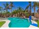 Resort-style backyard with a pool, rock waterfall, putting green, and lounge areas for relaxation at 17796 W Andora St, Surprise, AZ 85388