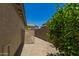 Side yard featuring a paver walkway and utilities, adding functionality to the outdoor space at 17796 W Andora St, Surprise, AZ 85388