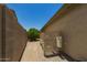 Paver walkway along side yard, leading to the backyard features, including utilities at 17796 W Andora St, Surprise, AZ 85388