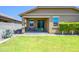 A covered patio extends to grassy backyard, ideal for entertaining or relaxing, with space to play and enjoy the outdoors at 18027 W Tina Ln, Surprise, AZ 85387