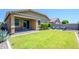 Expansive backyard with lush lawn and covered patio, perfect for outdoor living and entertainment at 18027 W Tina Ln, Surprise, AZ 85387