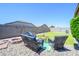 Serene backyard with a fire pit, comfortable seating, and lush green lawn at 18027 W Tina Ln, Surprise, AZ 85387