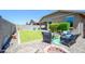 Inviting backyard with a cozy fire pit and comfortable wicker seating, perfect for outdoor relaxation at 18027 W Tina Ln, Surprise, AZ 85387