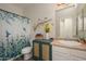 Charming bathroom featuring hummingbird themed accents and garden-inspired shower curtain at 18027 W Tina Ln, Surprise, AZ 85387