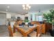 Open-concept dining room showcases a tile-topped table and seamless flow into the kitchen and living area at 18027 W Tina Ln, Surprise, AZ 85387
