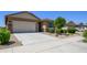 This lovely home boasts a two-car garage, desert landscaping, and a welcoming entrance at 18027 W Tina Ln, Surprise, AZ 85387