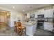 Modern kitchen featuring white cabinets, stainless steel appliances, and a center island with seating at 18027 W Tina Ln, Surprise, AZ 85387