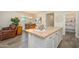 Open-concept kitchen with a center island, adjacent to a dining area and living space at 18027 W Tina Ln, Surprise, AZ 85387